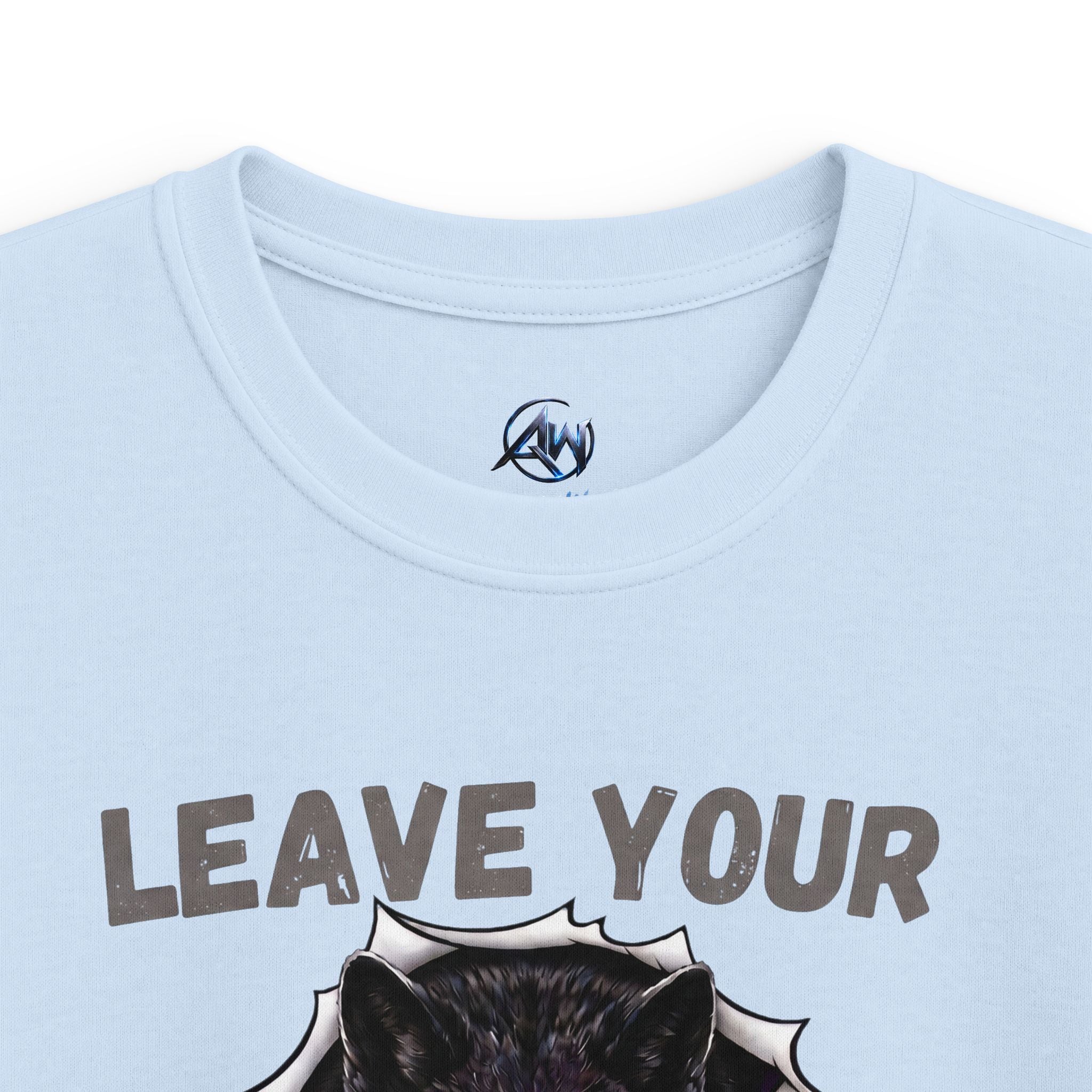 Close-up of a light blue crewneck t-shirt featuring a graphic print of a black wolf bursting through a white comic-style burst with the text 'LEAVE YOUR' in distressed gray letters. A circular 'AW' logo is printed inside the collar.