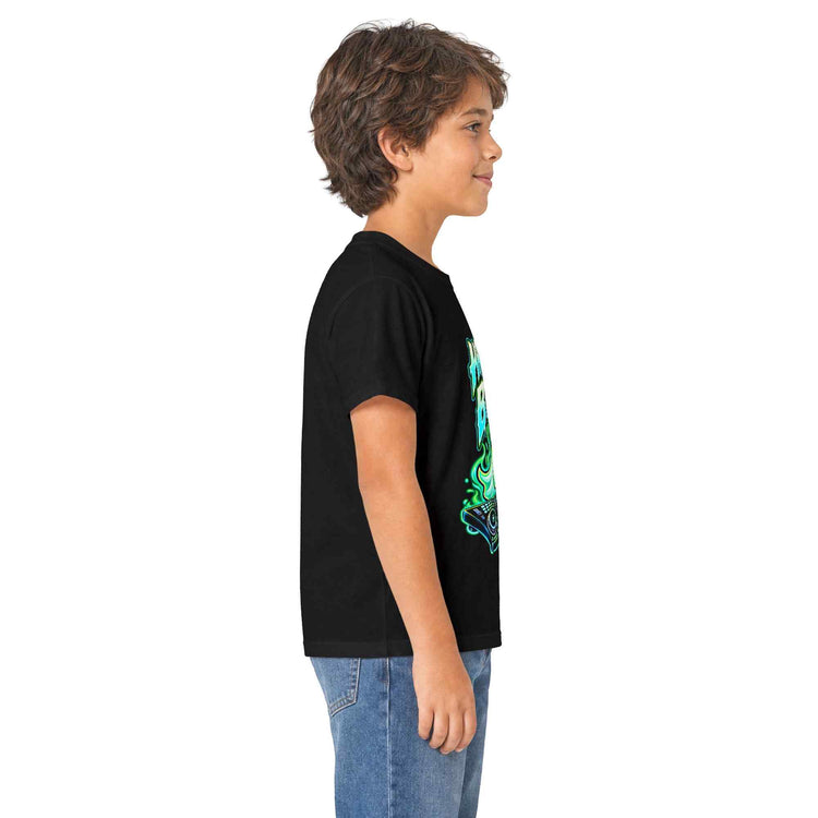 A child model shown in side profile wearing a black short-sleeve t-shirt with a vibrant green and blue graphic print on the front, paired with blue jeans, against a plain white background.