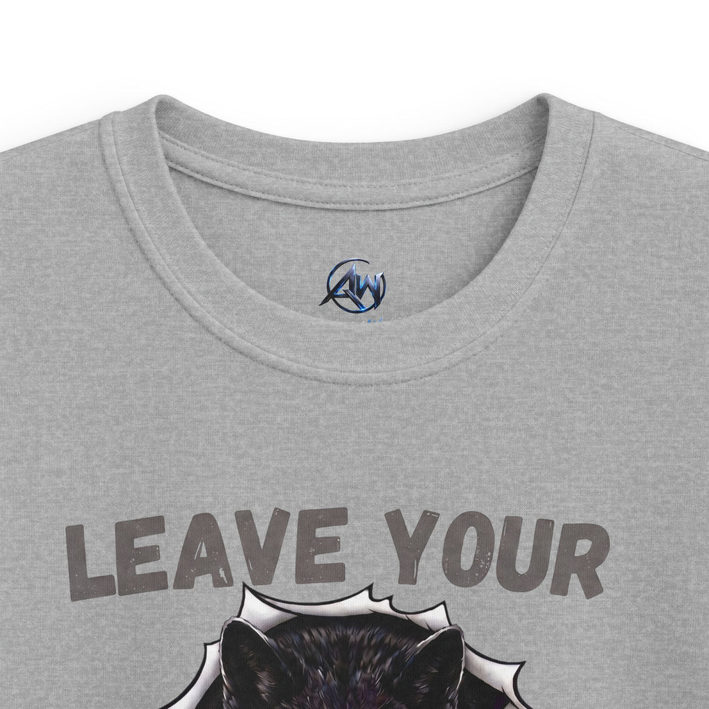 Close-up of a heather gray t-shirt featuring the text 'LEAVE YOUR' above a graphic of a black wolf head bursting through a white jagged shape. A small circular blue and black logo is printed inside the collar.