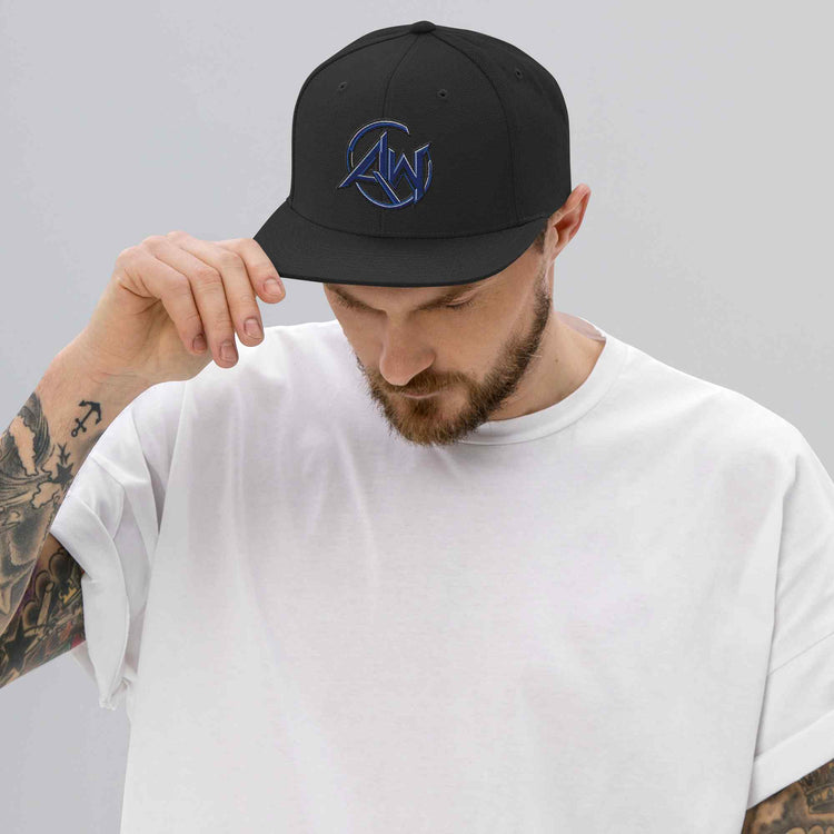 Man wearing a navy cap with 'AW logo on a gray background
