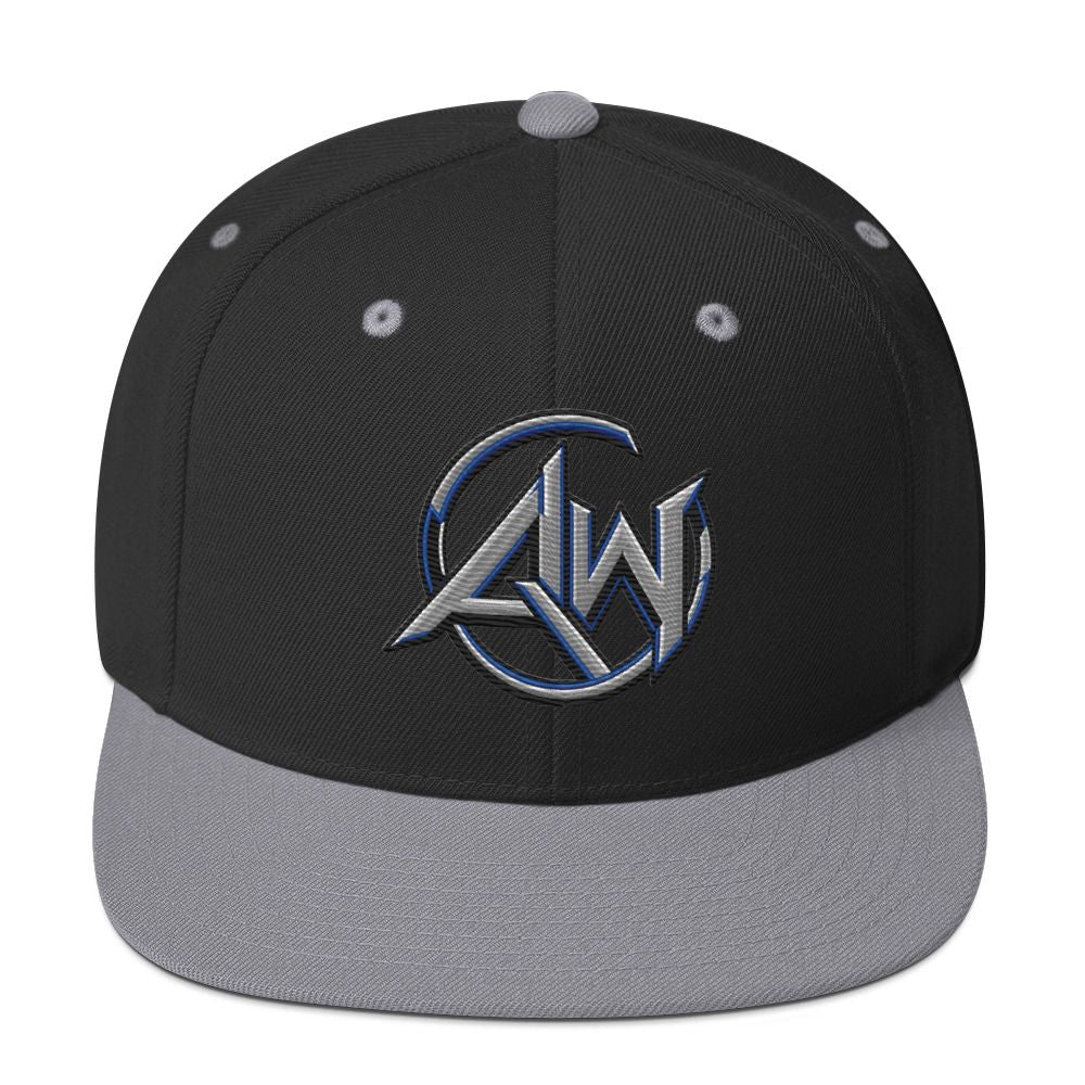 A structured snapback cap with a black crown, gray flat brim, and a metallic silver and blue embroidered 'A.W' logo on the front.