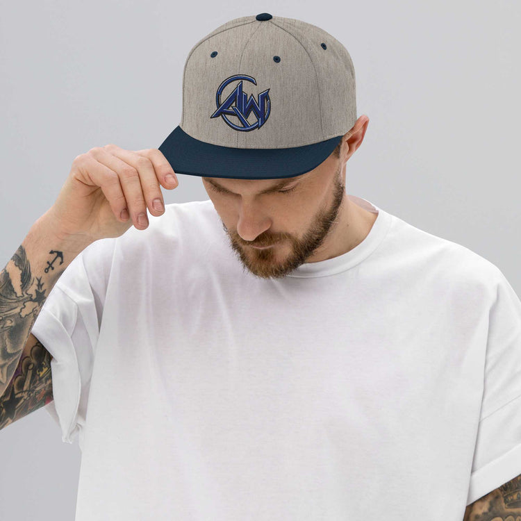 Man wearing a cap with AW logo on a plain background