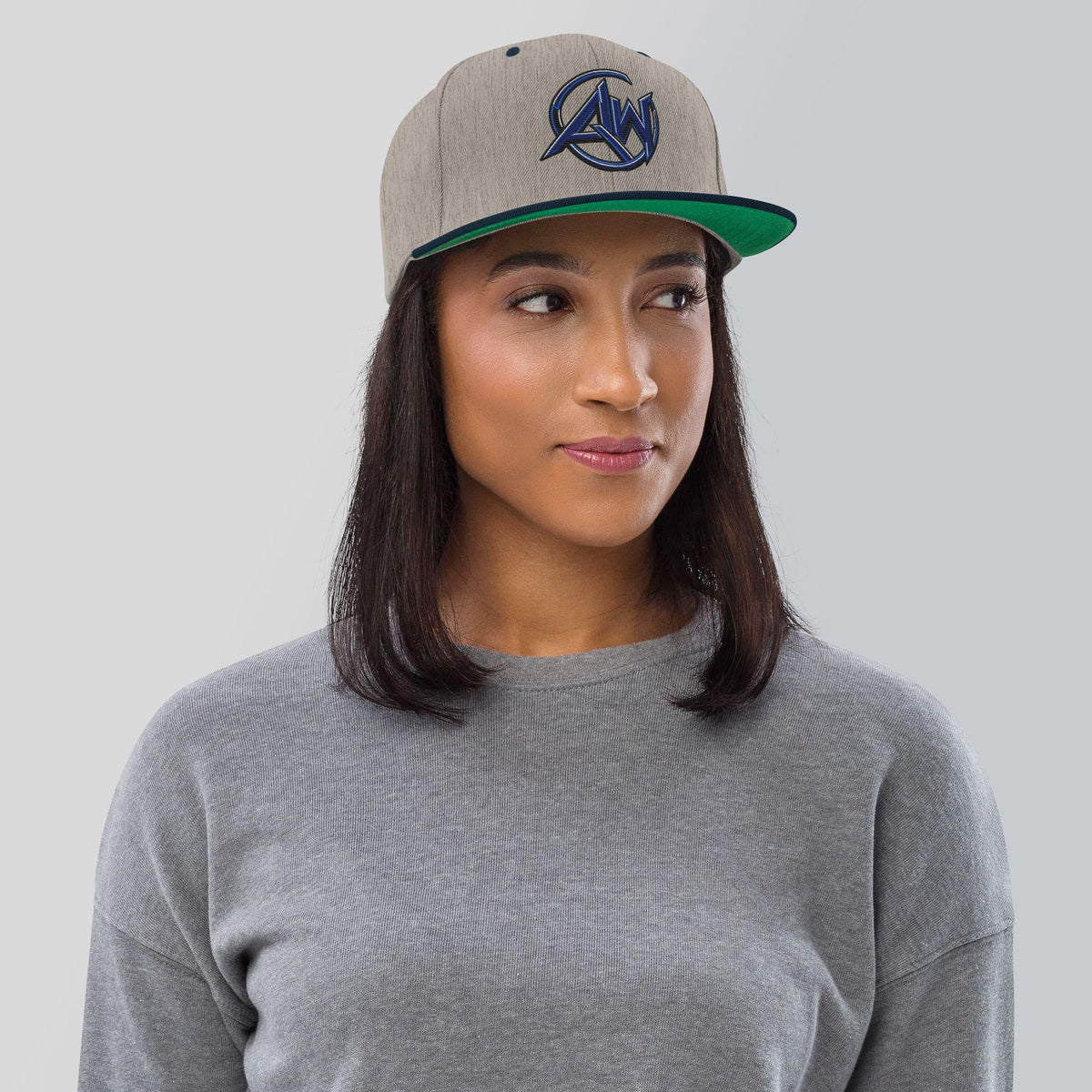 Woman wearing a cap with 'logo AW text on a plain background