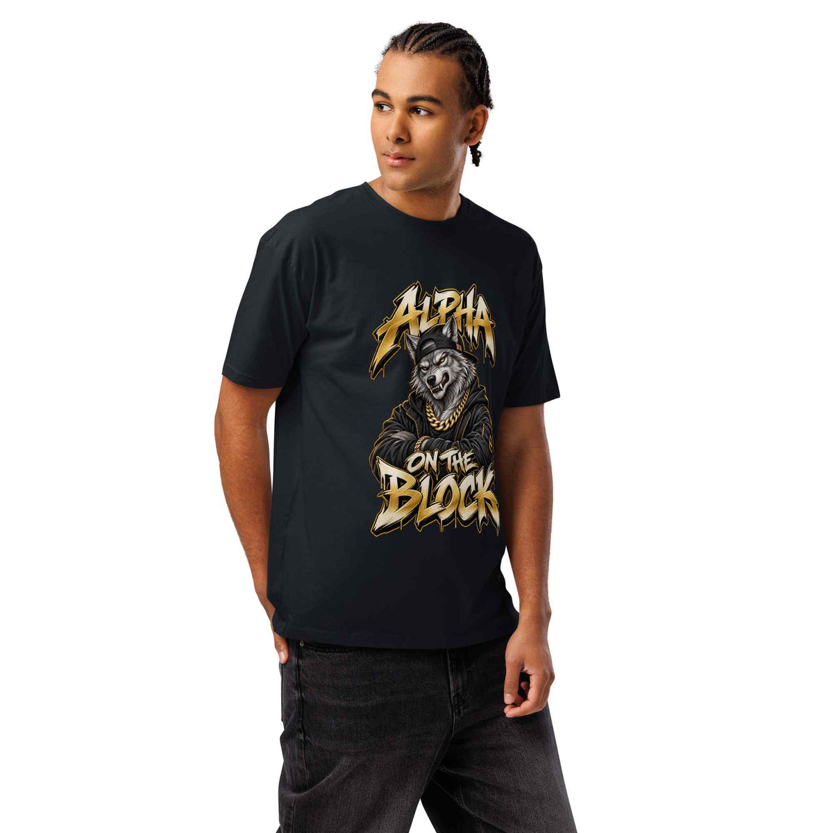 A man wearing a black short-sleeve graphic t-shirt with a gold and white 'Alpha on the Block' wolf print, paired with dark gray jeans, against a plain white background.