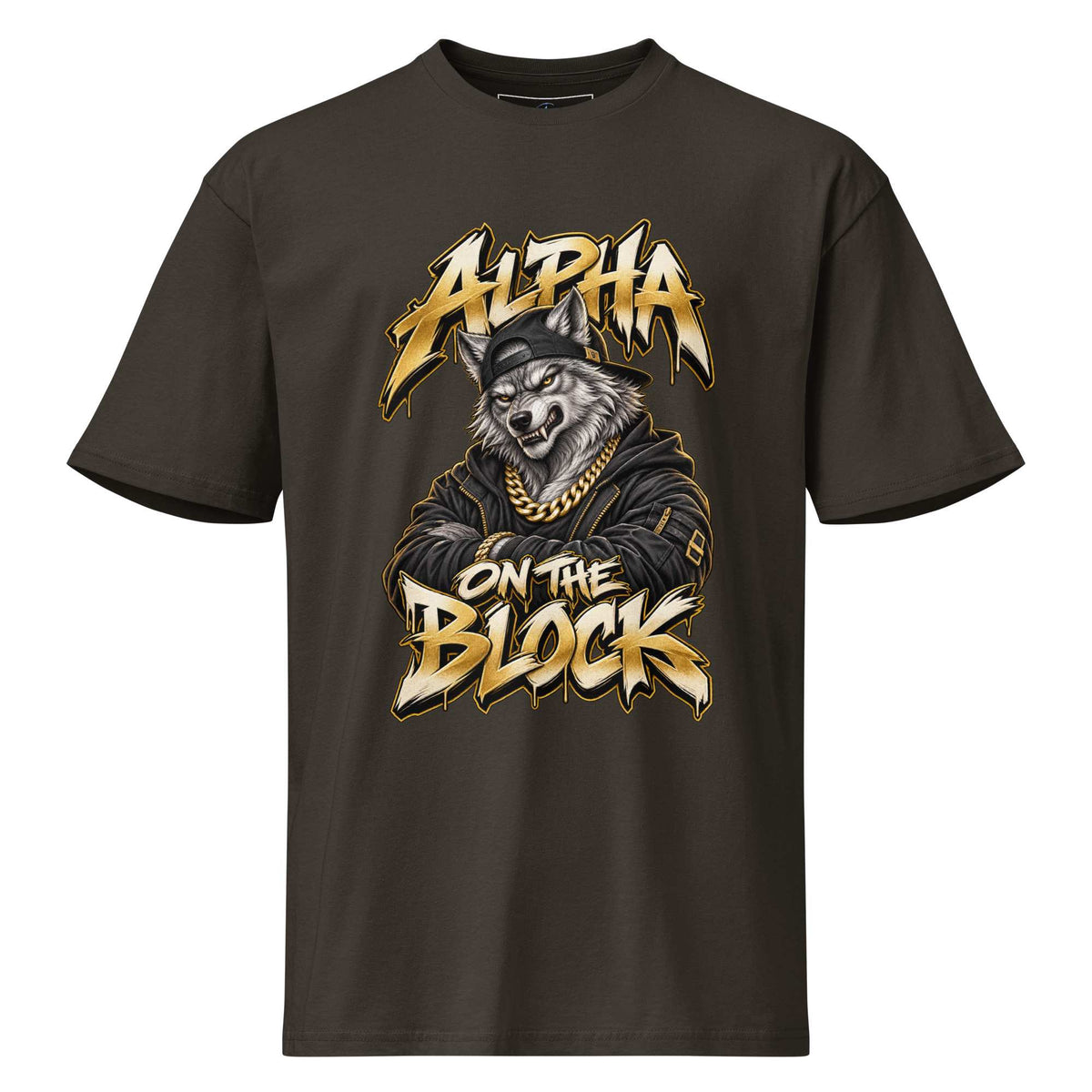 A dark brown short-sleeve t-shirt with a graphic print of a wolf wearing a gold chain and cap, with the text 'ALPHA ON THE BLOCK' in a stylized gold and white font.