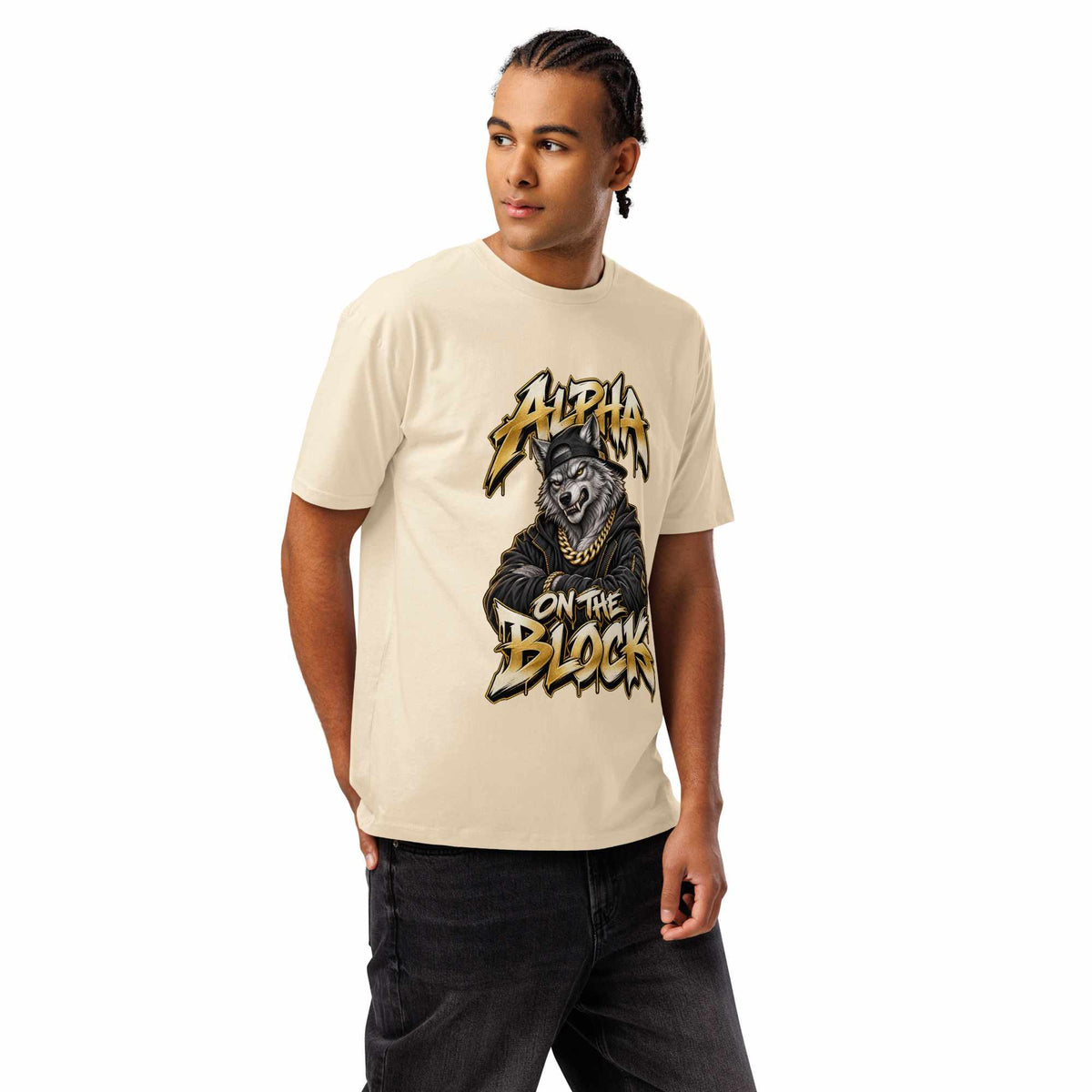A man wearing a cream-colored t-shirt with a black and gold graphic of a wolf and the text 'ALPHA ON THE BLOCK'.