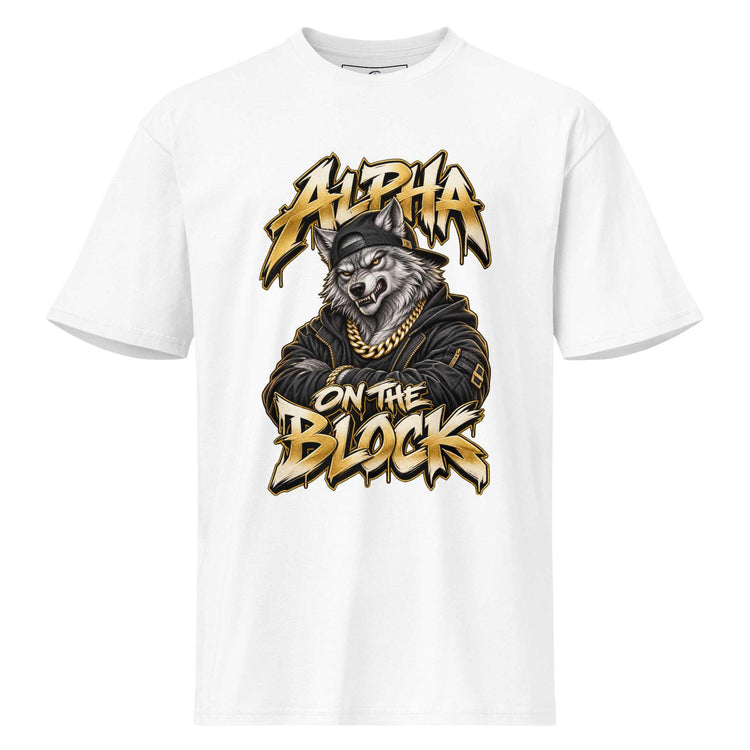 A white short-sleeve crewneck t-shirt featuring a large graphic print of a wolf wearing a gold chain and black jacket, with the text 'ALPHA ON THE BLOCK' in a stylized gold and black font.