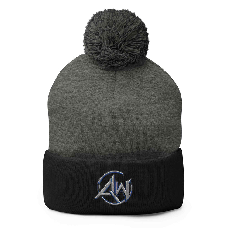 A dark gray and black knit pom-pom beanie with a white embroidered AW logo on the cuff, shown against a plain white background.