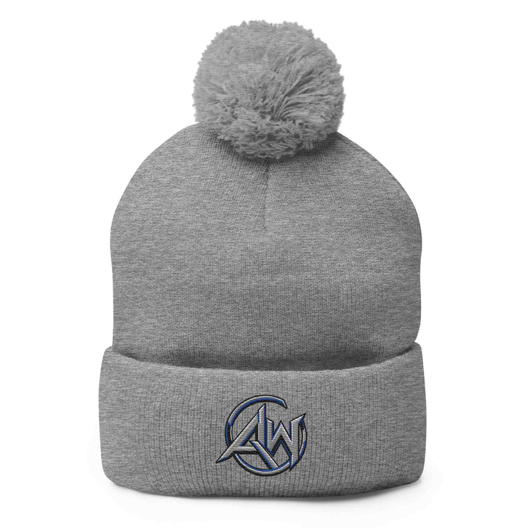 A heather gray knit beanie with a matching gray pom-pom on top and a folded cuff. A small graphic patch on the front cuff features the text 'AW logo