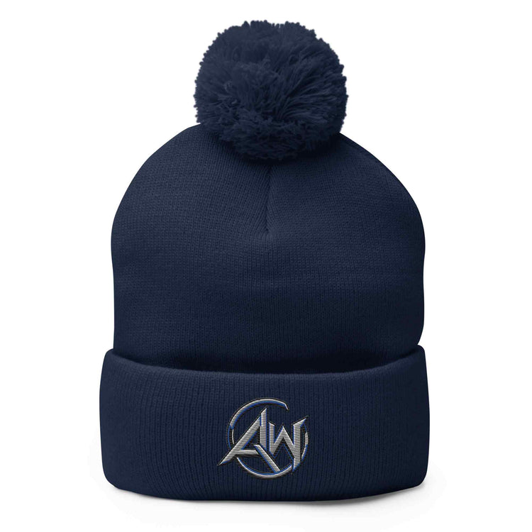 A navy blue knit beanie hat with a matching pom-pom on top and a folded cuff featuring a small white embroidered AW logo