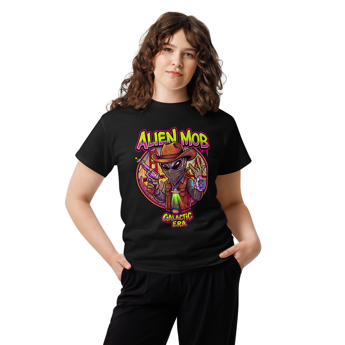 A woman modeling a black short-sleeve graphic t-shirt with a colorful 'Alien Mob Galactic Era' design on the front, set against a plain white background.