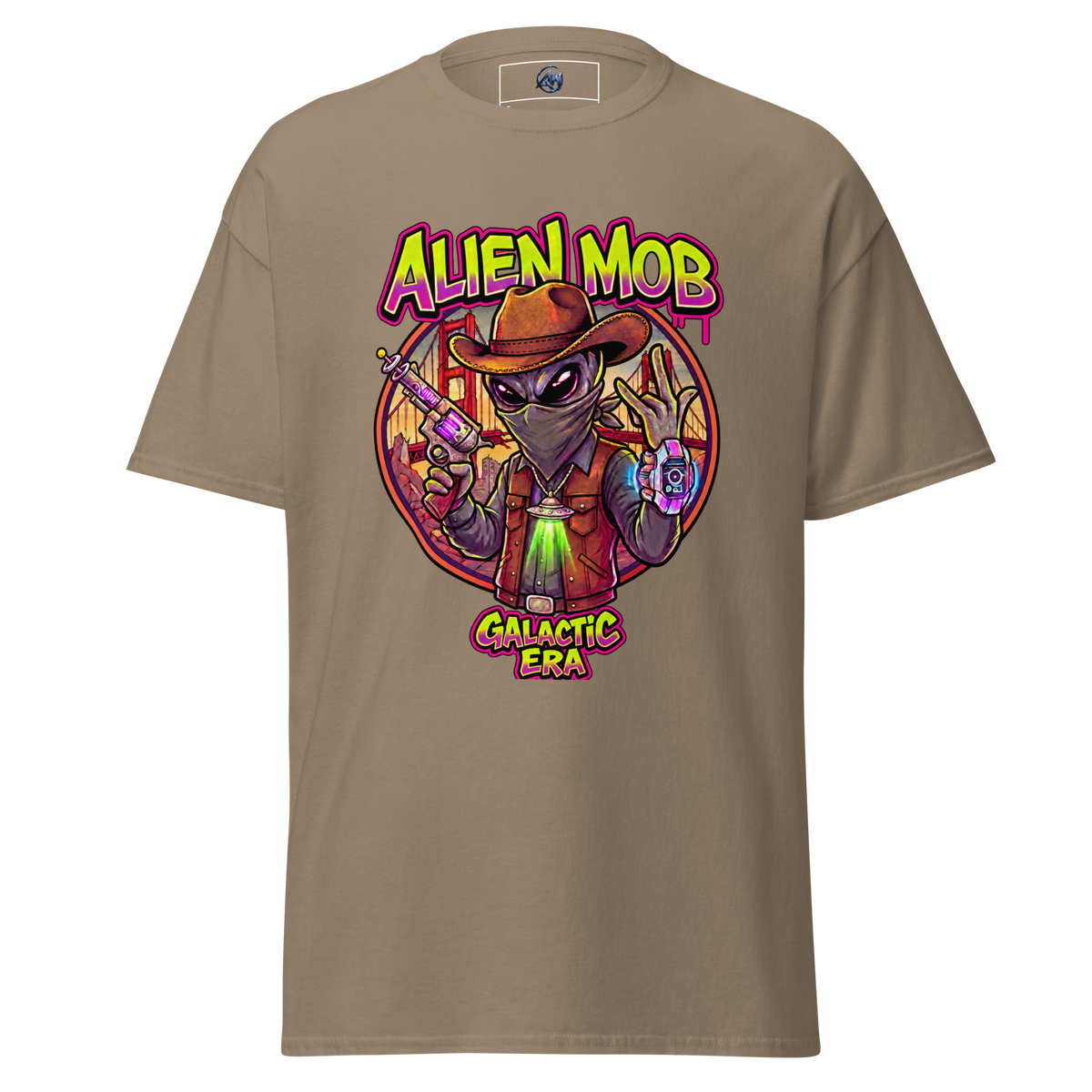 A savana brown short-sleeve t-shirt with a colorful graphic print of an alien wearing a cowboy hat and vest, holding a gun, with the text 'ALIEN MOB' and 'GALACTIC ERA'.