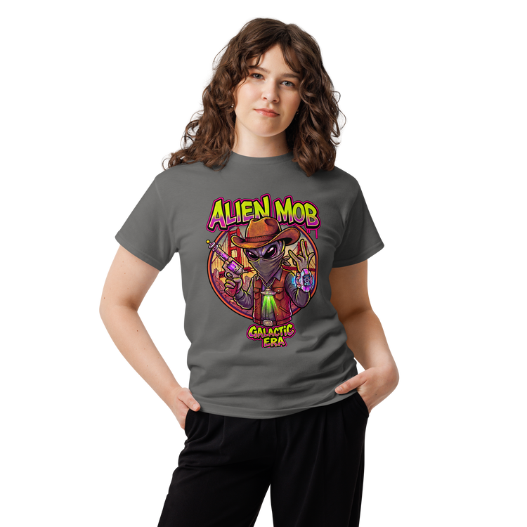 A woman modeling a dark gray t-shirt with a colorful graphic of an alien wearing a cowboy hat and vest, with the text 'ALIEN MOB' and 'GALACTIC ERA'.
