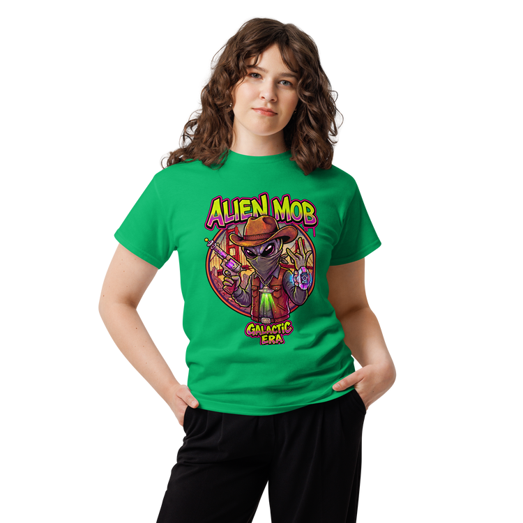 A woman modeling a bright green t-shirt with a colorful graphic print featuring an alien character and the text 'ALIEN MOB' and 'GALACTIC ERA'.