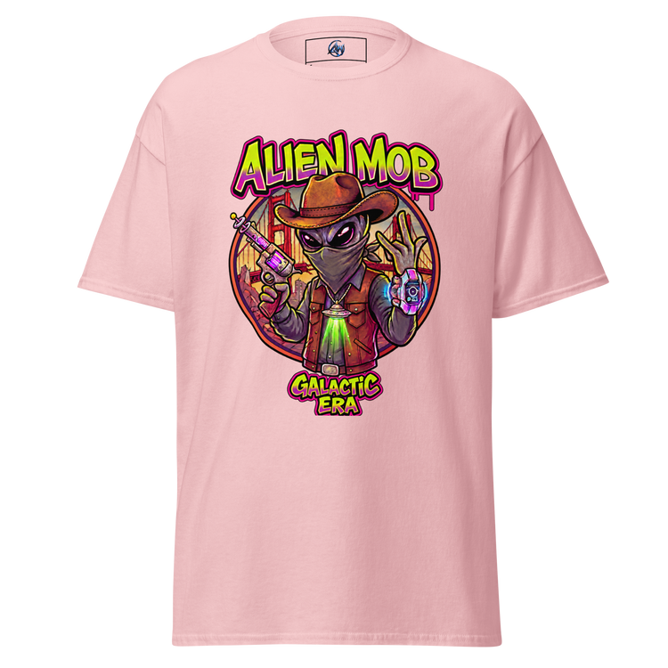 A light pink short-sleeve t-shirt with a colorful graphic print on the front. The graphic features a cartoon alien wearing a brown hat and vest, holding a gun, with the text 'ALIEN MOB' above and 'GALACTIC ERA' below.