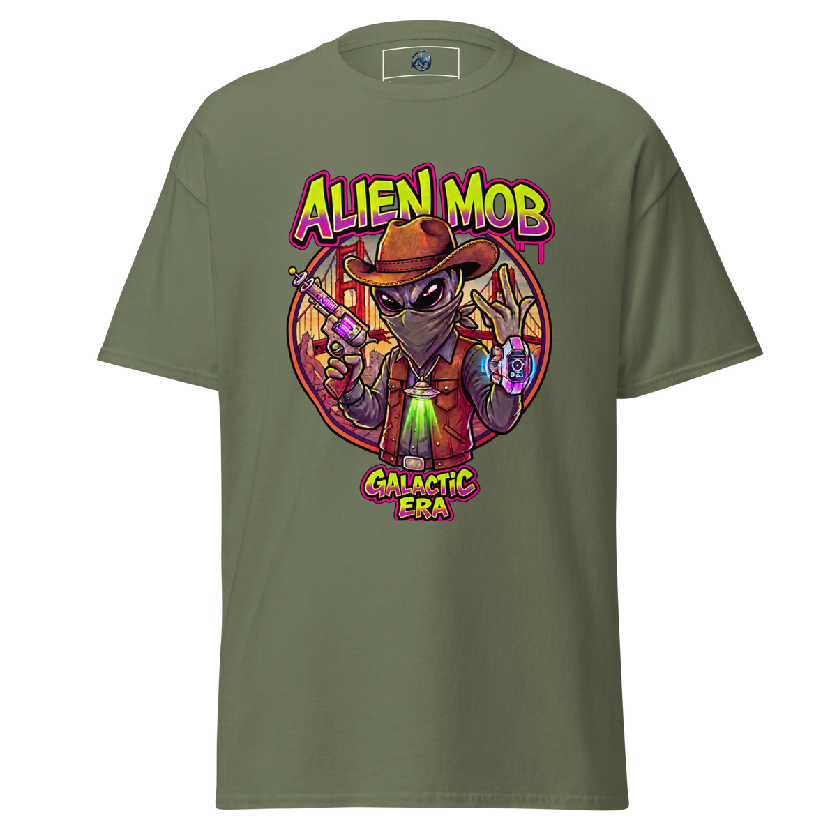 An olive green short-sleeve t-shirt with a colorful graphic print on the front. The graphic features a cartoon alien wearing a brown hat and vest, holding a purple device, with the text 'ALIEN MOB' above and 'GALACTIC ERA' below.