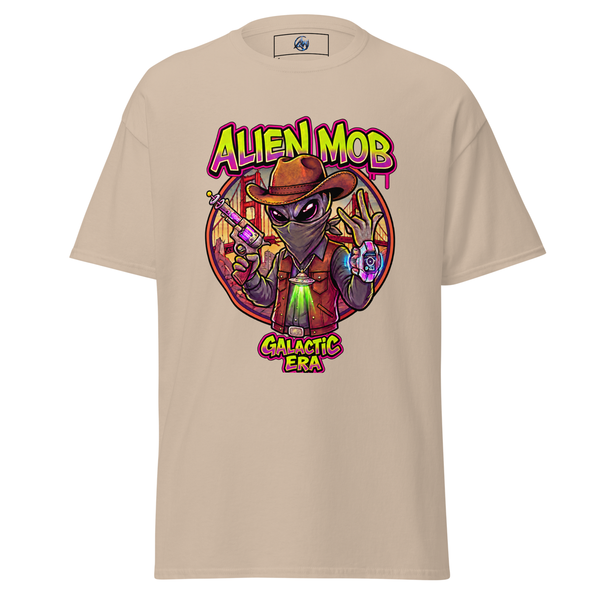 A Sand short-sleeve t-shirt with a colorful graphic print of an alien wearing a cowboy hat and vest, holding a gun, with the text 'ALIEN MOB' and 'GALACTIC ERA' on a white background.