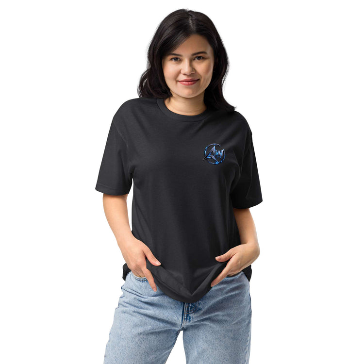 A woman modeling a black short-sleeve t-shirt with a small blue circular graphic AW logocon the left chest, paired with light blue jeans, against a plain white background.