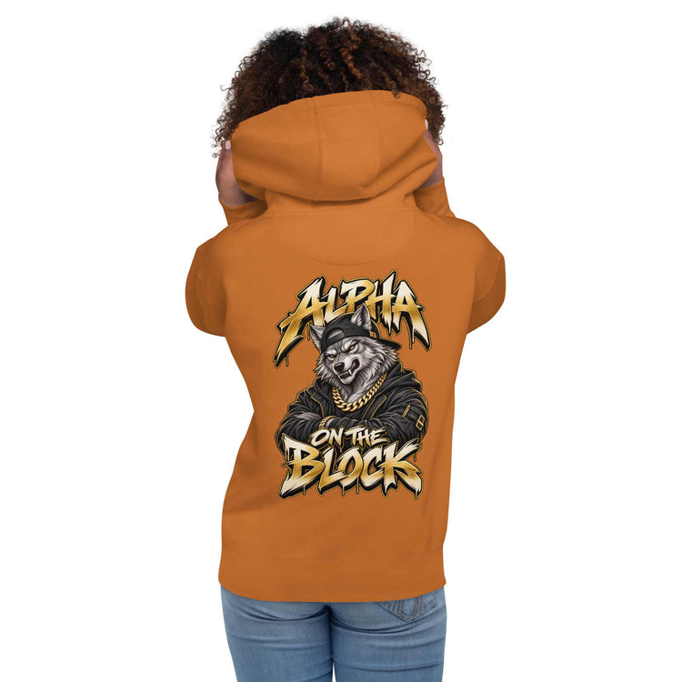 A woman shown from the back wearing an orange hoodie with a large graphic wolf on the back  and the text 'ALPHA ON THE BLOCK'.