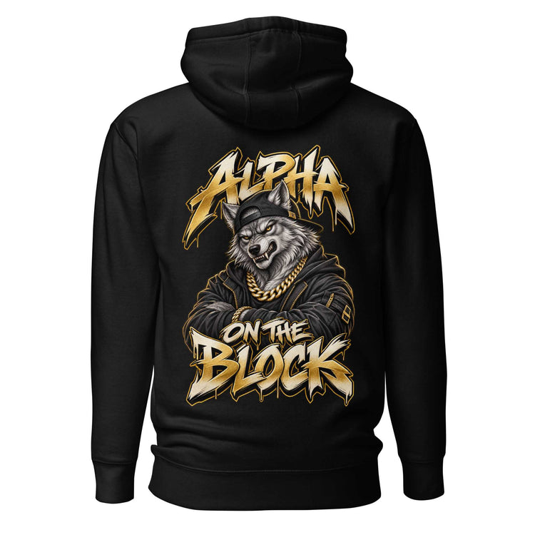 A black pullover hoodie shown from the back, featuring a large graphic print of a wolf wearing a gold chain and cap, with the text 'ALPHA ON THE BLOCK' in a stylized gold and white font.