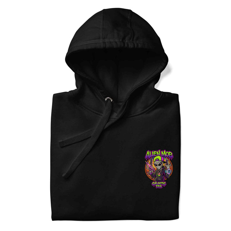 A folded black hoodie on a white background, featuring a colorful graphic on the left chest with the text 'ALIEN MOB' and 'GALACTIC MOB' around a cartoon alien illustration.