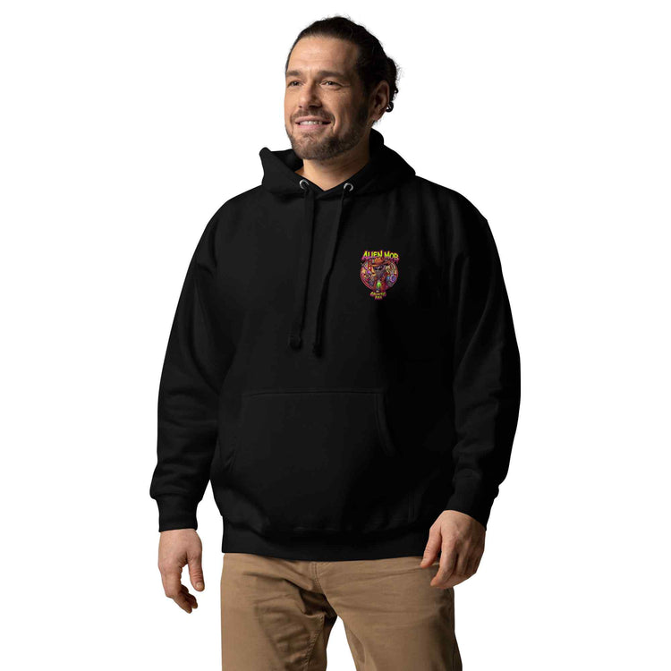 man wearing a black color hoodie with a logo on the left side chest of a design alien mob cowboy outlaw paired with khaki jeans on a white background front view