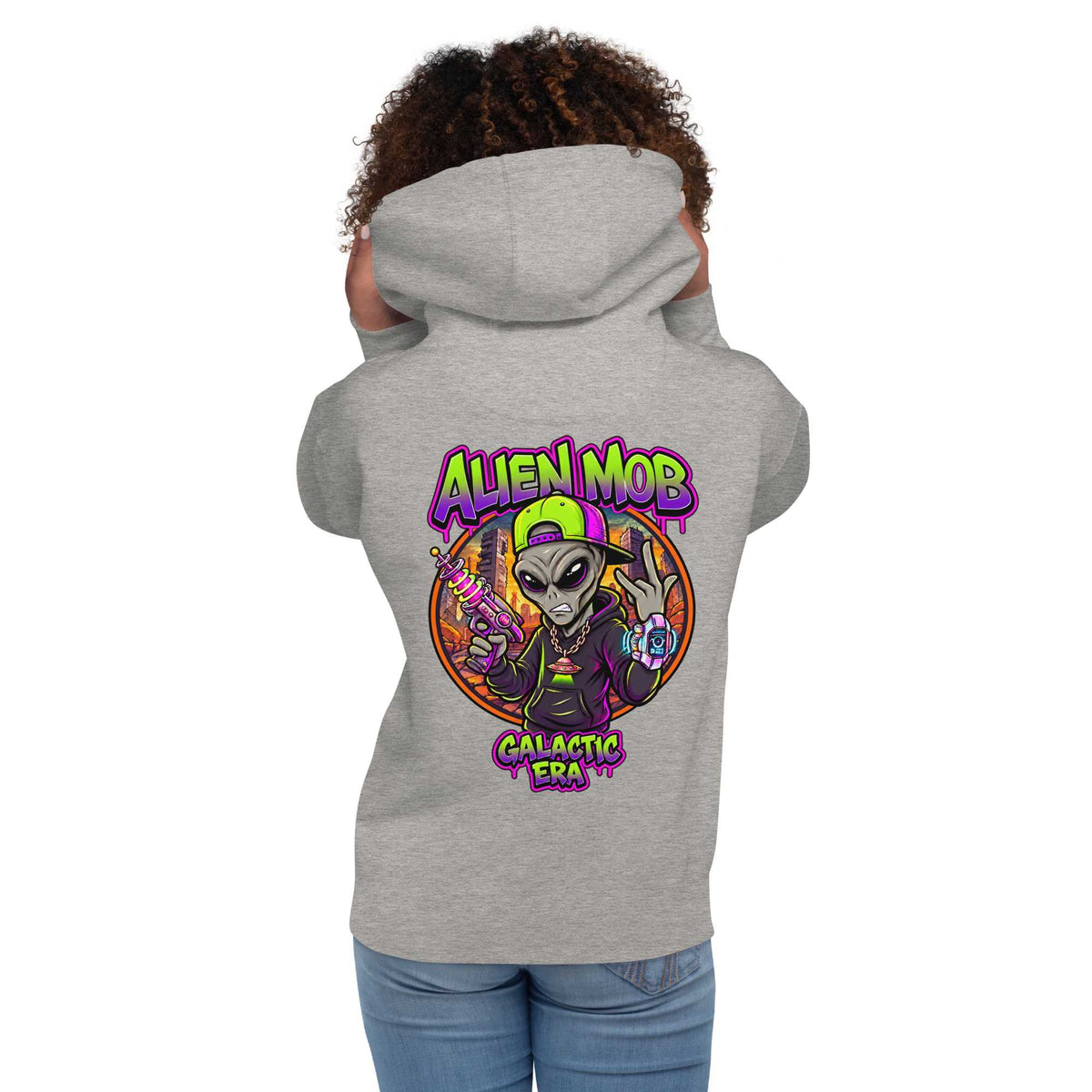 A woman shown from the back wearing a Carbon stone light gray hoodie with a large colorful graphic on the back featuring an alien character and the text 'ALIEN MOB' and 'Galactic Era'.