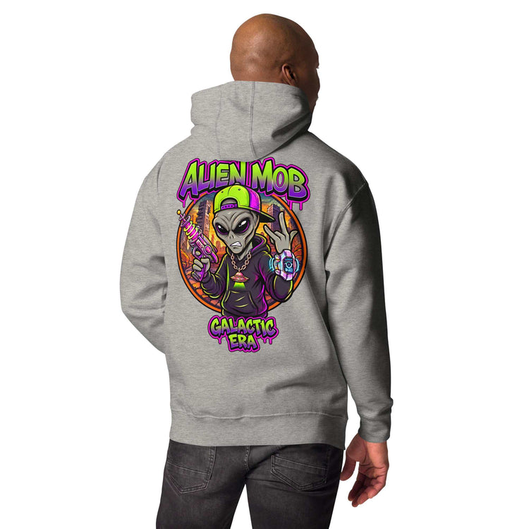 A man shown from the back wearing a Carbon stone light gray hoodie with a large colorful graphic on the back. The graphic features the text 'ALIEN MOB' and 'Galactic Era' with an illustrated alien in a purple suit and green cap.