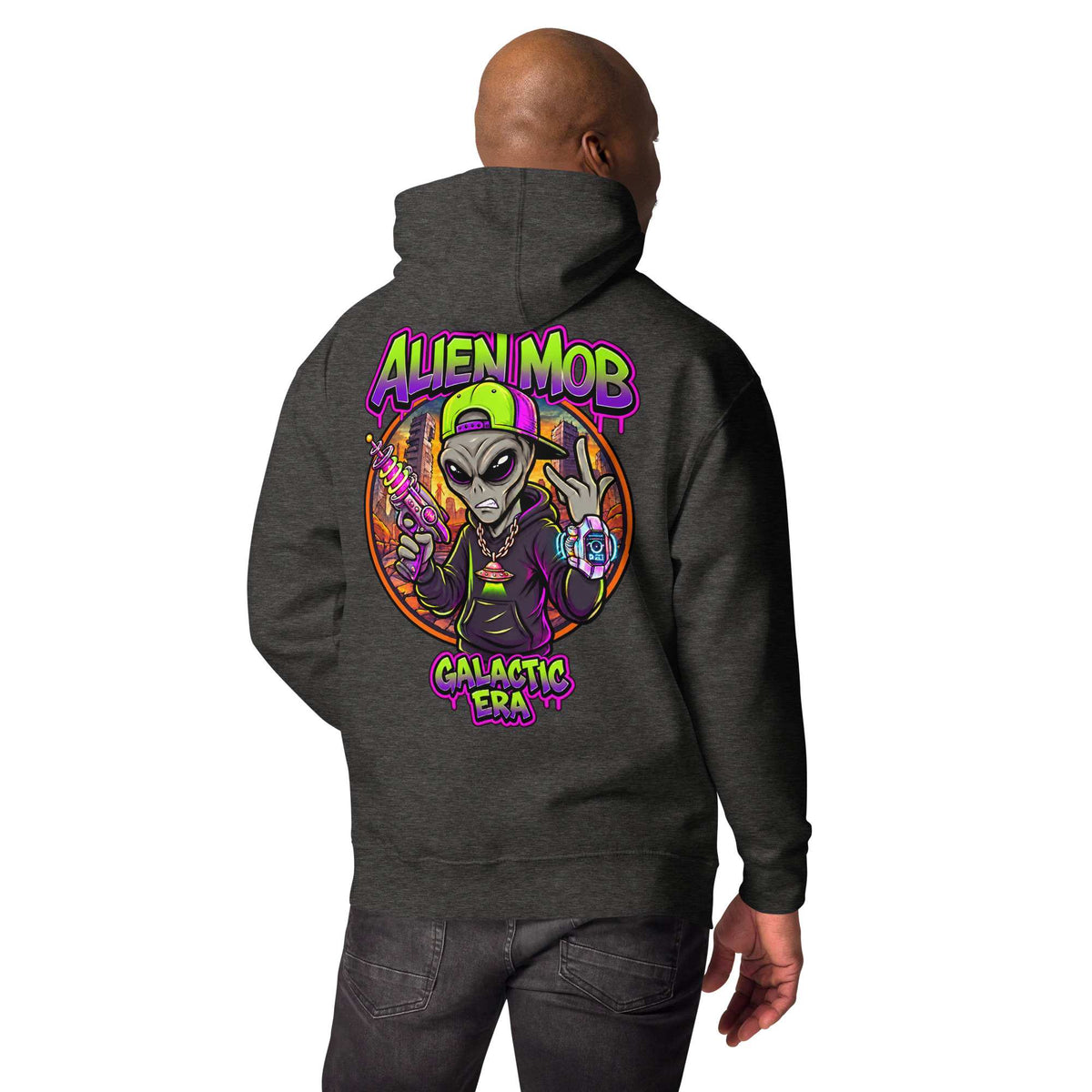 A man shown from the back wearing a dark charcoal gray hoodie with a large colorful graphic on the back. The graphic features an alien character with a green cap and the text 'ALIEN MOB GALACTIC ERA' in neon purple and green lettering.