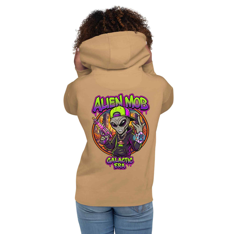 A woman shown from the back wearing a khaki color hoodie with a large colorful graphic on the back. The graphic features the text 'ALIEN MOB' and 'Galactic Era' around an illustration of a cartoon alien.