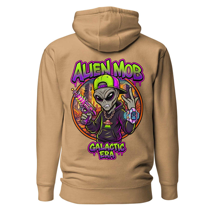 A khaki color  pullover hoodie shown from the back, featuring a large colorful graphic of an alien holding a gun with the text 'ALIEN MOB GALACTIC ERA' in purple and green.