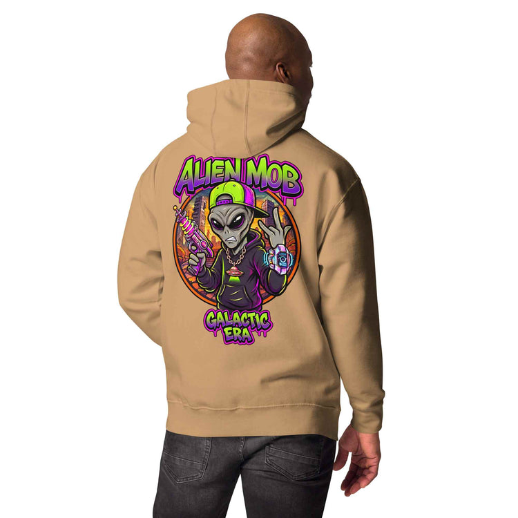 A man shown from the back wearing a khaki color  hoodie with a large colorful graphic on the back featuring an alien and the text 'ALIEN MOB GALACTIC ERA'.
