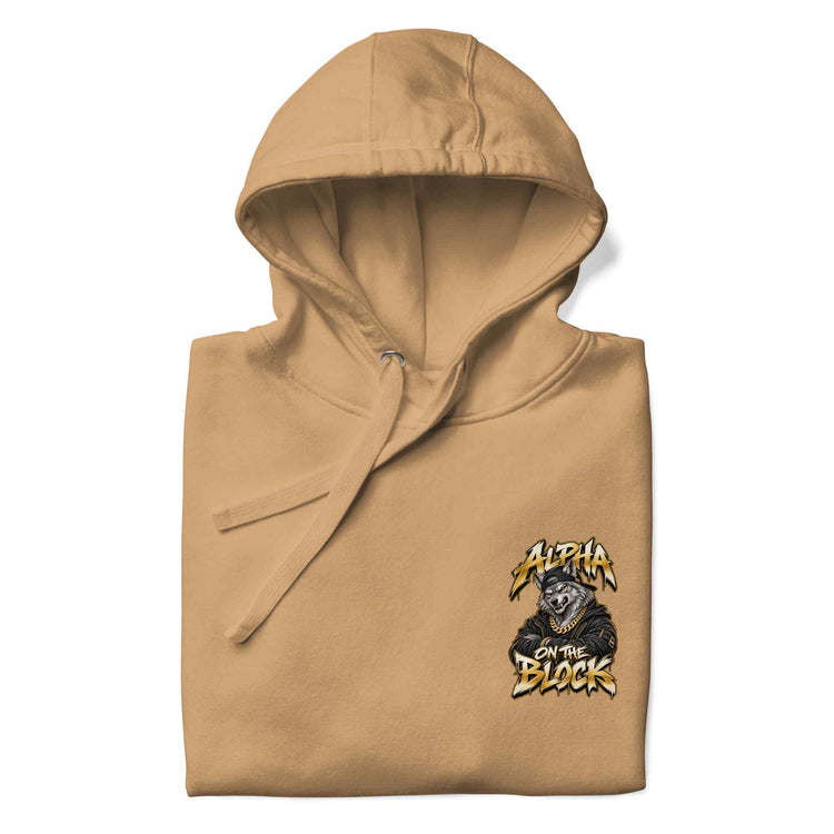 A folded tan hoodie with a small graphic on the left chest featuring a wolf and the text 'Alpha on the Block' in yellow and black, shown on a white background.