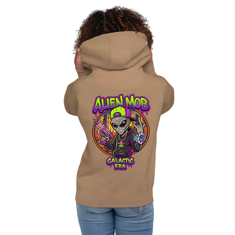A woman shown from the back wearing a latte color hoodie with a large colorful graphic on the back. The graphic features the text 'ALIEN MOB' and 'GALACTIC ERA' around an illustrated alien character.
