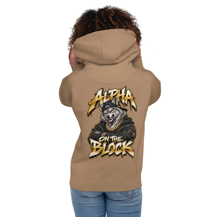A woman shown from the back wearing a tan hoodie with a large graphic print on the back featuring a wolf and the text 'ALPHA ON THE BLOCK'.