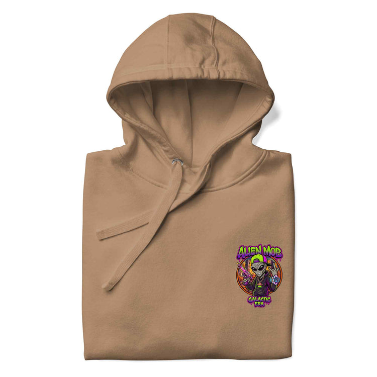 A folded latte color  hoodie with a colorful 'Alien Mob ' graphic printed on the left chest, displayed on a clean white background.
