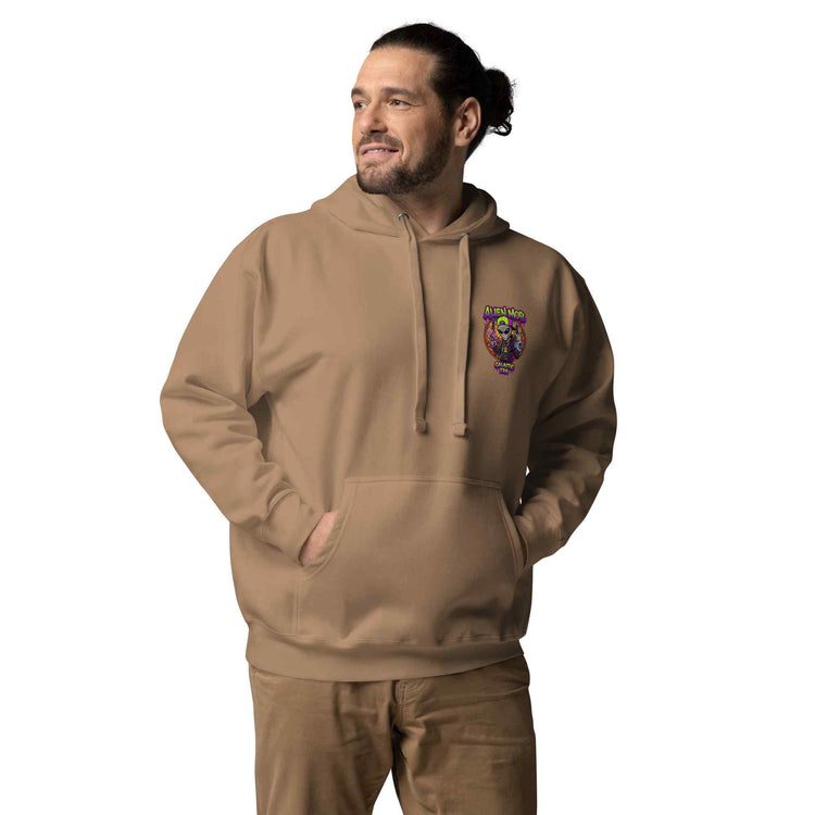 Man wearing a latte color hoodie with an alien mob logo on  left side chest  on a white background