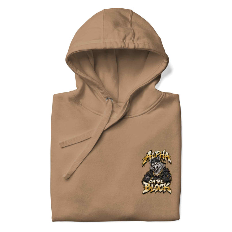 A folded tan hoodie with a small chest graphic reading 'Alpha on the Block' featuring a wolf illustration, shown on a plain white background.