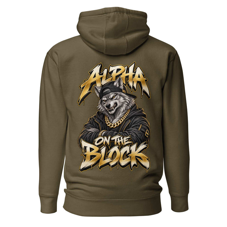 An olive green pullover hoodie shown from the back, featuring a large graphic print of a wolf wearing a black beanie and gold chain, with the text 'ALPHA ON THE BLOCK' in a stylized gold and black font.