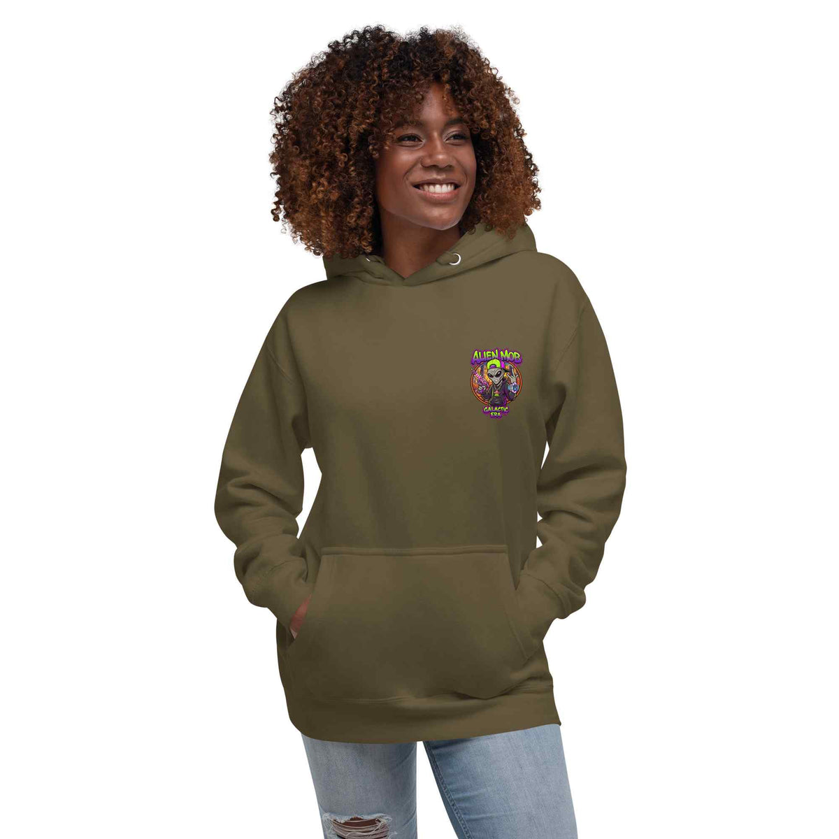 a woman with brown curly hair wearing a military color hoodie with an alien mob ' text  logo on the left side chest on a white background
