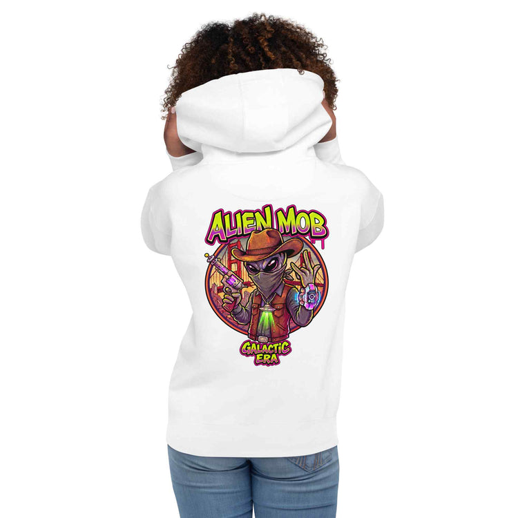 woman wearing a white hoodie with alien mob cowboy outlaw  on the back of the hoodie paired with blue jeans on a white background back view