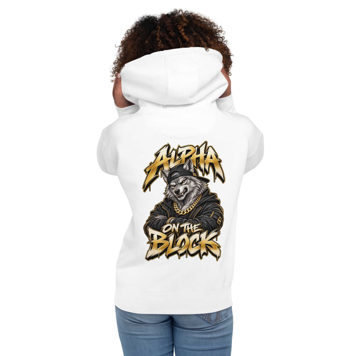 A woman shown from the back wearing a white hoodie with a large graphic print on the back. The graphic features a wolf wearing a cap and gold chain with the text 'ALPHA ON THE BLOCK' in a stylized gold and black font.