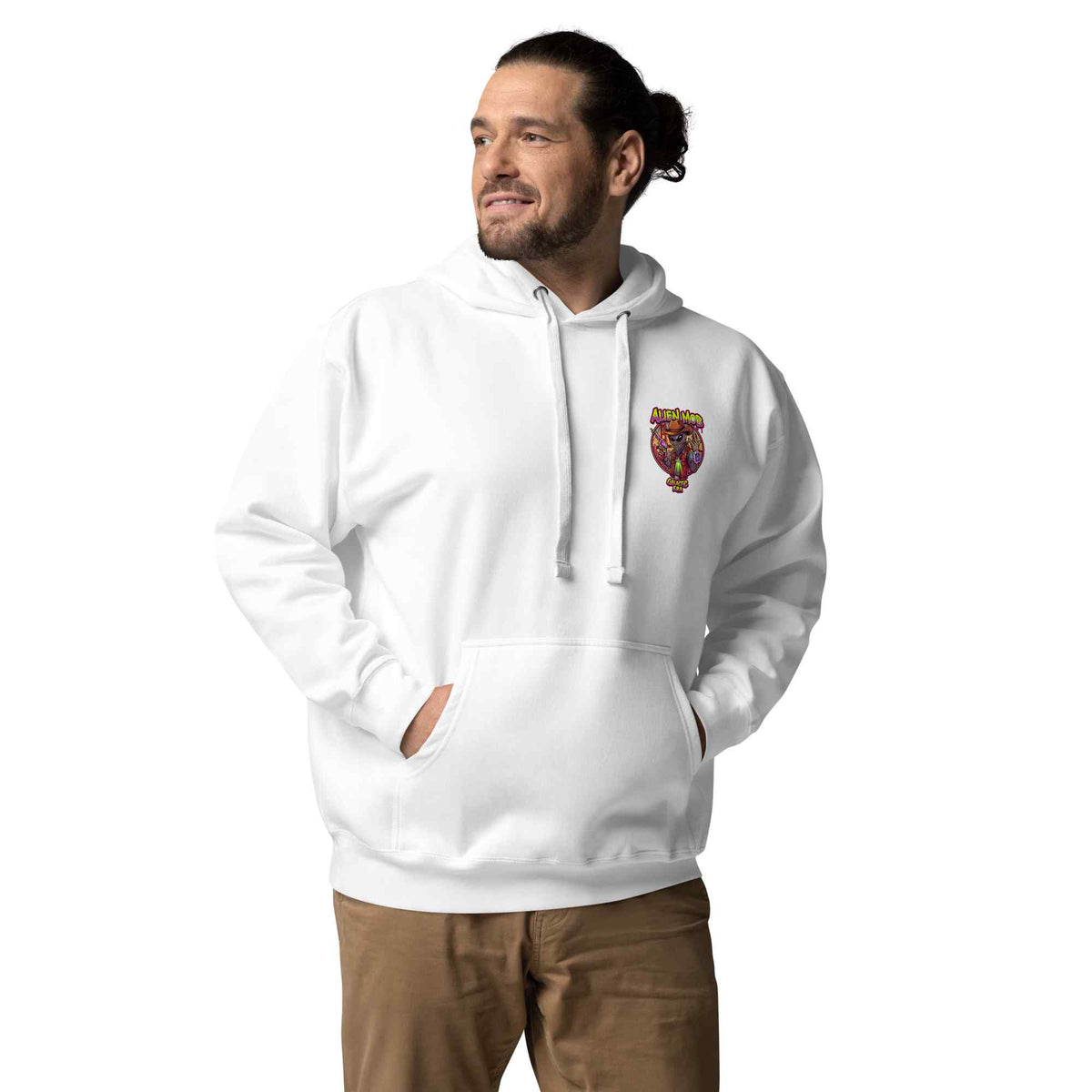 man wearing a white color hoodie with a logo on the left side chest of a design alien mob cowboy outlaw paired with khaki jeans on a white background front view