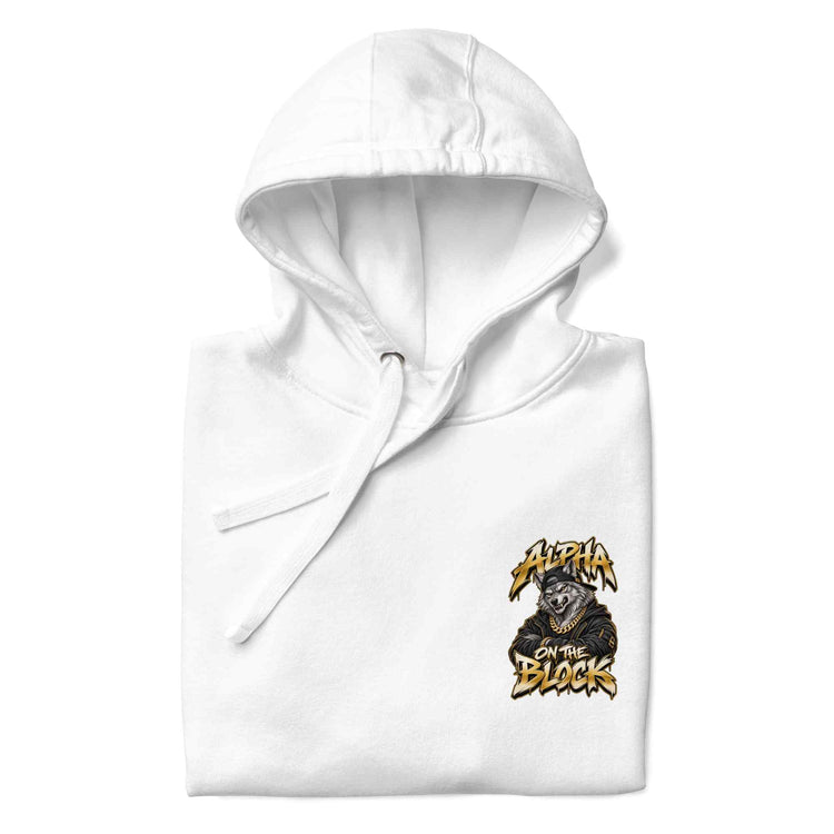 A folded white hoodie with drawstrings, featuring a graphic print wolf on the left chest of a wolf wearing a black hoodie with the text 'ALPHA ON THE BLOCK' in a stylized yellow font. 