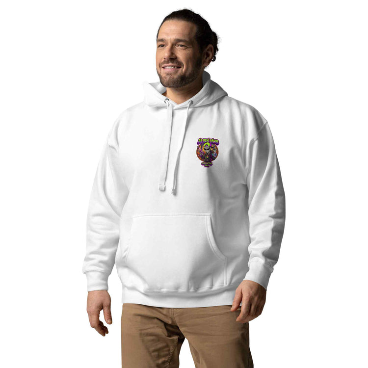 A man wearing a white pullover hoodie with a colorful alien mob logo graphic on the left chest, paired with brown pants, set against a plain white background.