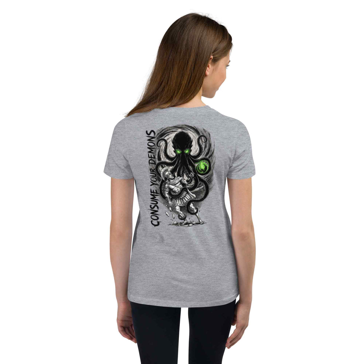 A woman shown from the back wearing a heather gray t-shirt with a large graphic print of a black octopus-like creature with green eyes and the text 'CONSUME YOUR DEMONS' on the back.