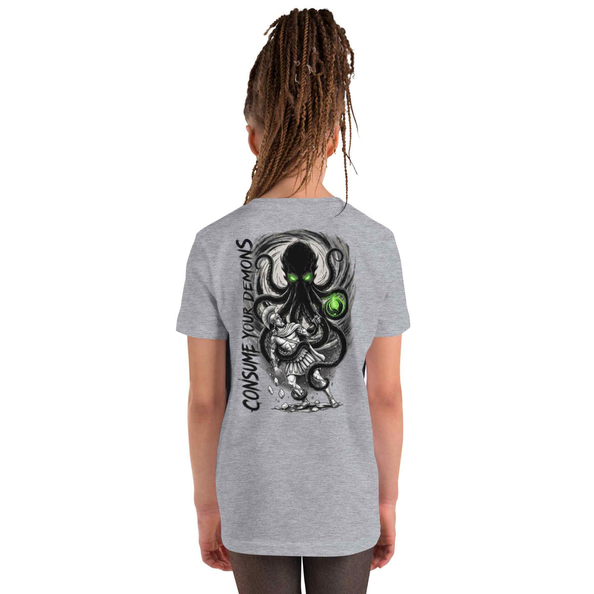 A girl with long brown dreadlocks is shown from the back wearing a heather gray t-shirt with a large graphic of a black octopus with green eyes and the text 'CONSUME YOUR DEMONS' printed on the back.