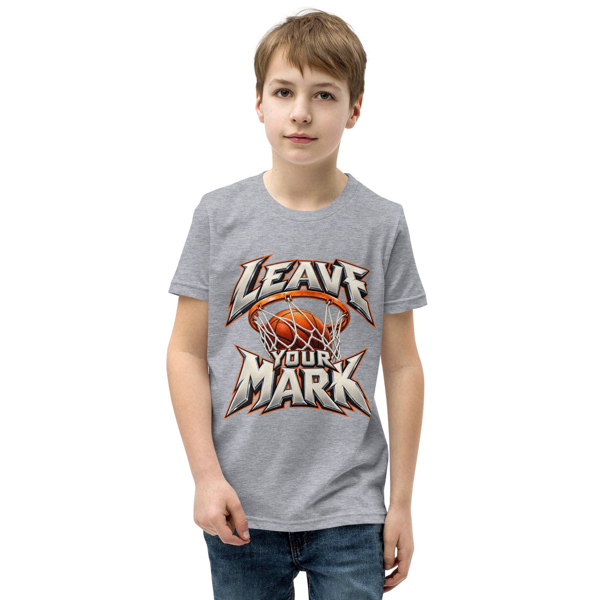 A young boy wearing a heather gray t-shirt with a basketball graphic that reads 'LEAVE YOUR MARK' in stylized white and orange lettering, set against a plain white background.