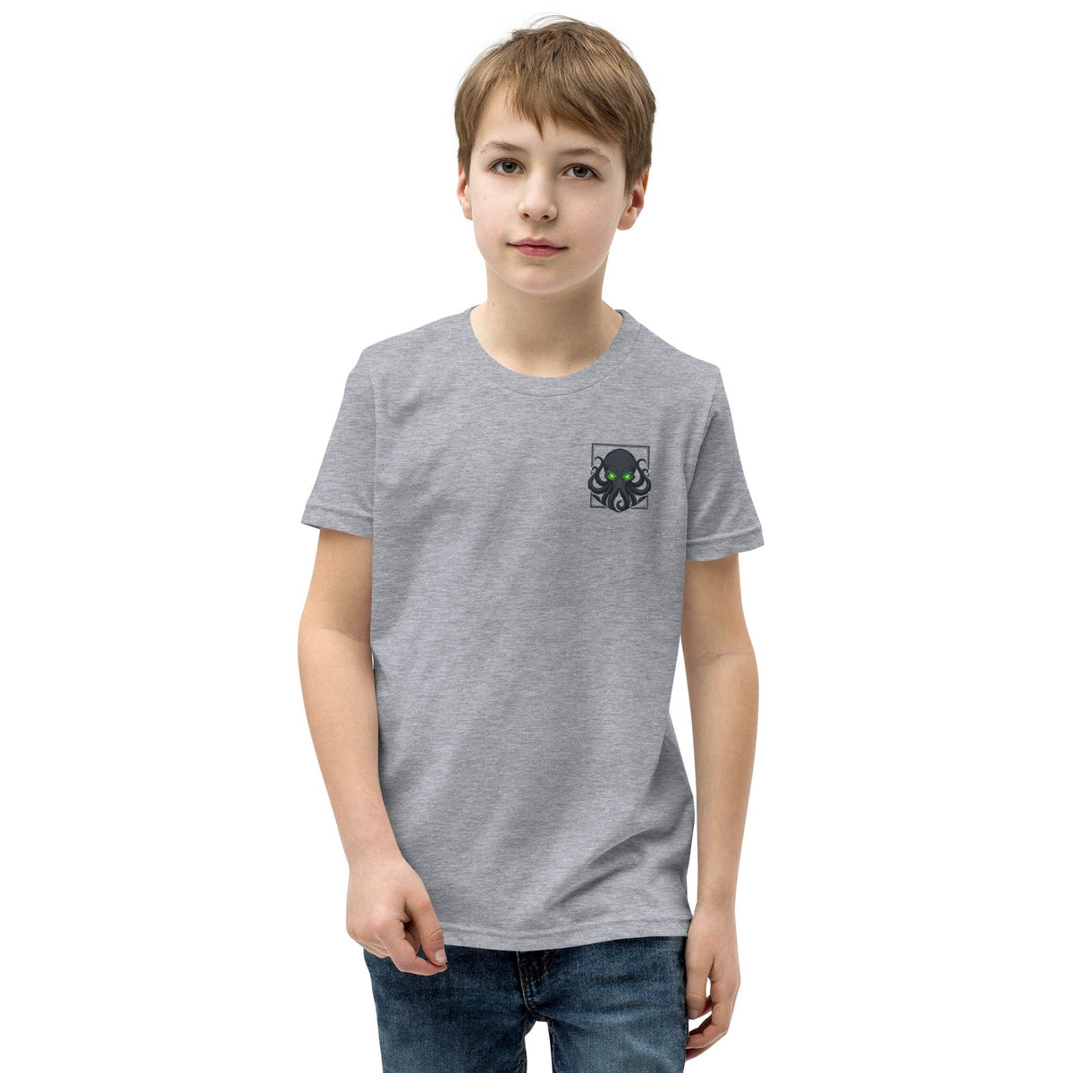 Child wearing a gray t-shirt with a kraken design on a white background