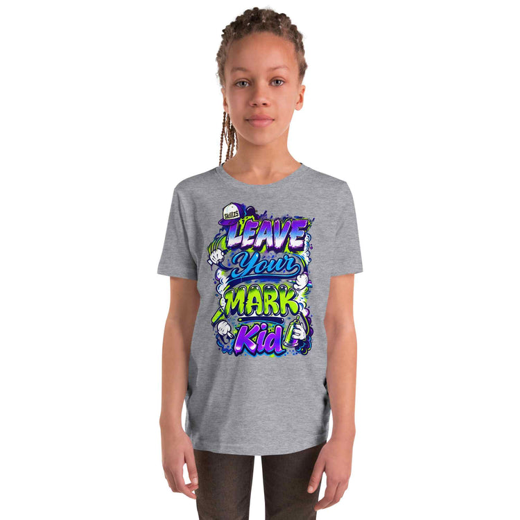 A young girl with braided hair wearing a heather gray t-shirt with a colorful graphic that reads 'LEAVE YOUR MARK Kid' in purple, blue, and green, set against a plain white background.